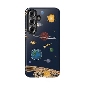 May include: A navy blue phone case featuring a colorful space-themed design. The case displays planets, stars, and a sun illustration. The phone case has a camera module with three lenses.