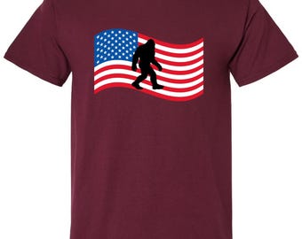 Bigfoot Cryptid American Flag T-Shirt, Unisex Cotton Sasquatch Graphic Tee for Nature Lovers and Hikers