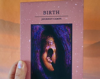 May include: A pink box with the title "BIRTH JOURNEY CARDS" and the text "EARTH SCULPTURES BY DEBRA BERNIER". The box features a photo of a wooden sculpture of a woman giving birth.
