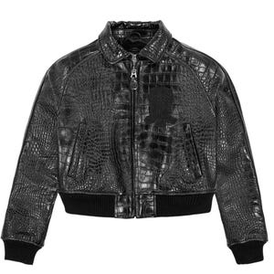 May include: A black bomber jacket featuring a textured crocodile skin pattern throughout. The jacket includes a front zipper closure, a standard collar, two side pockets, and black ribbed knit cuffs and hem. A dark patch is visible on the chest.