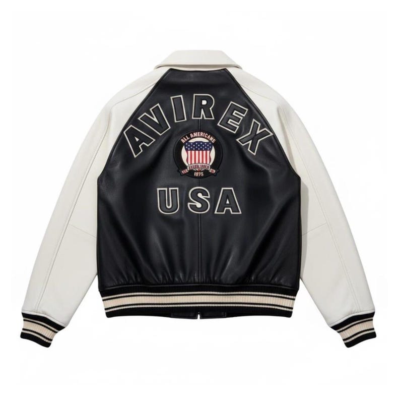 May include: A black and white varsity jacket featuring white sleeves and a black body. The back displays the text AVIREX in an arc above a circular patch with an American flag and the text ALL AMERICANS ESTABLISHED 1975, with USA below.