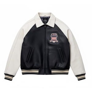 May include: A black and white jacket with a front zipper closure, a fold-down collar, and long sleeves. The chest features a patch with the text "AVIREX" above an American flag graphic. The cuffs and hem have black and white striped ribbing.
