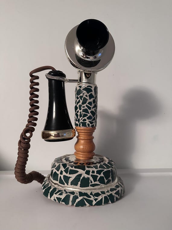 A real vintage telephone transformed into a mosaic sculpture with green tiles — functional trash turned into genuinely striking mixed-media art.