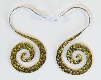 May include: A pair of gold-toned earrings with a spiral design. The earrings have a hammered texture and are attached to silver hooks.
