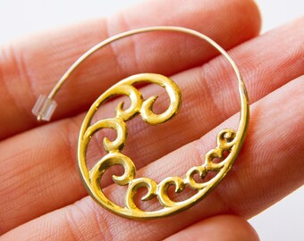 May include: A gold hoop earring with a decorative spiral design. The earring is made of metal and has a simple, elegant style.