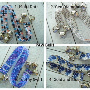 May include: Four PAW Bells with different patterned ribbons and silver bells. The patterns include multi-dots, geo diamonds, toothy swirl, and gold and blue designs. Each bell set has a white base.
