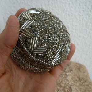 vintage,small,round,tin box,covered in silver beads,star design on lid,felt lined,small gift or jewelry box