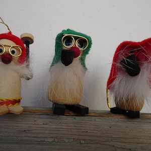 lot of 3,vintage,wooden gnomes with wire glasses,hanging Christmas tree decorations.