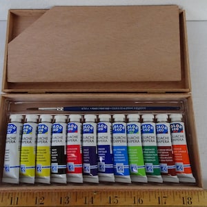 small,vintage,simple wooden painters box with 12 tempera paints,brass cherubs embellishment.