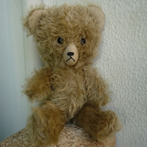 vintage,big headed,soft stuffed,small,mohair bear,fixed head jointed limbs,black,glass eyes.