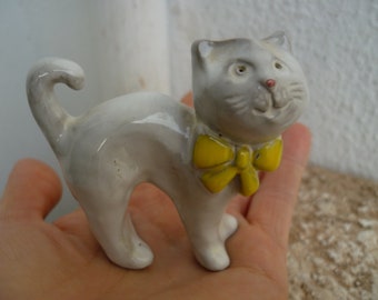 vintage,small,glazed,ceramic,clay,pale grey,gray with yellow bow tie,figurine 2 3/4'' w. x 2 1/2'' h.