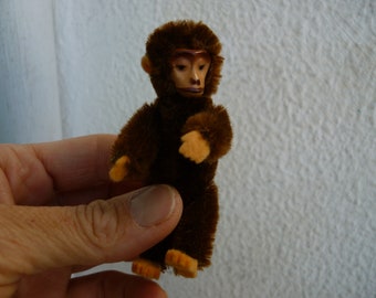 1930's miniature,9 cm.Schuco monkey,ape,tin face,mohair over metal body,jointed limbs.