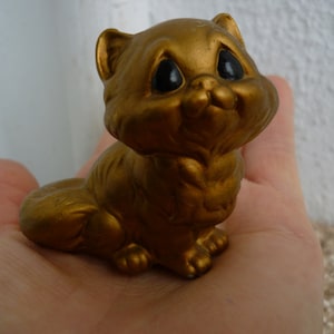 vintage,gold painted,clay or ceramic,small cat figurine,black eyed kitten.