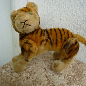RARE,vintage Steiff,fully jointed tiger,5'' h.damaged & worn,glass eyes,mohair,swivel head,jointed limbs,silverscript button