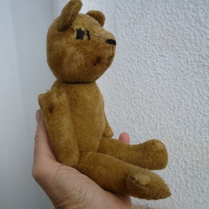 antique,small,very primitive,handmade ? teddy bear,straw stuffed,wire joints,sewn eyes & nose.