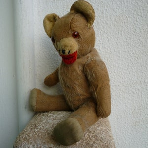 antique,very worn,battered,darned,teddy bear,wood excelsior,unknown maker.