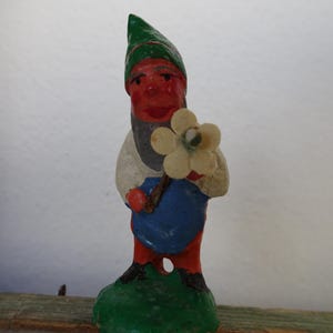antique,5 cm.miniature,German,composition,gnome,elf holding flower,C.1900-1920 in wooden egg.