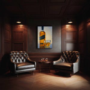 May include: An oil painting of a bottle of Johnnie Walker Black Label whiskey and a glass of whiskey with ice. The painting hangs on a dark wall in a room with two leather armchairs and a small table.