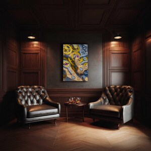 May include: An oil painting of watch gears and components in yellow, blue, and silver tones hangs on a dark wall. The room features two tufted leather armchairs, a small round table, and a wooden floor.