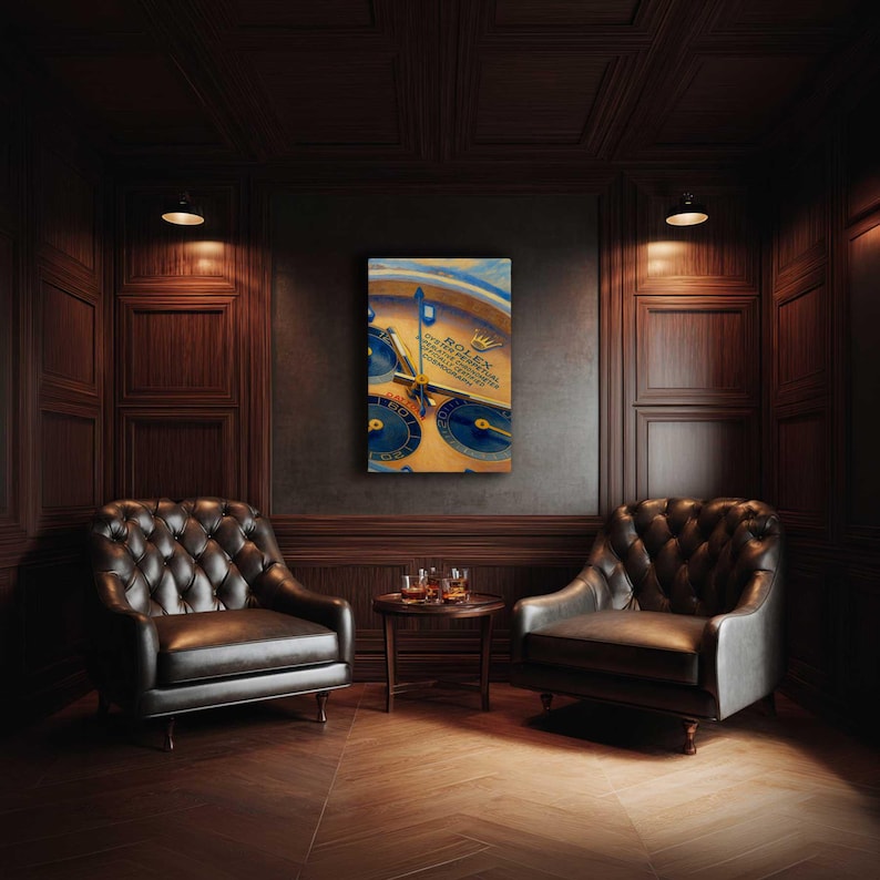 May include: A framed artwork featuring a close-up of a Rolex watch face with blue and gold accents. The artwork hangs on a dark wall between two leather armchairs in a room with wood paneling and a small table with glasses.