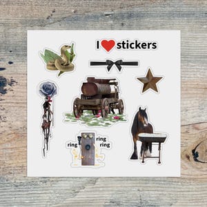 May include: A sheet of stickers with various designs, including a snake with leaves, a black bow, a rusty wagon, a star, a horse with a table, a rose, and a vintage telephone with the word "ring". The text "I heart stickers" is also present.