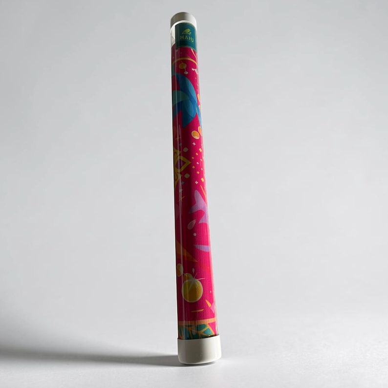 May include: A cylindrical storage tube with a vibrant magenta background featuring a colorful graphic pattern of abstract shapes, leaves, and circles in shades of blue, yellow, and orange, topped with a white cap and a small green logo label.