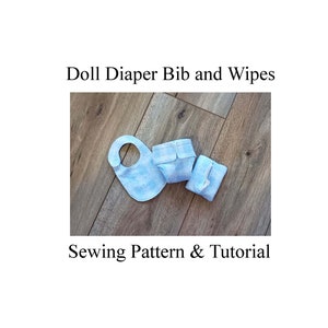 May include: A sewing pattern and tutorial for a doll diaper, bib, and wipes. The items are made of blue fabric with white polka dots.