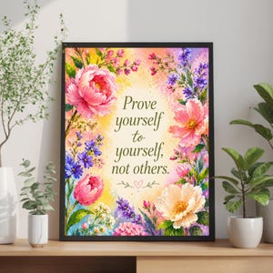 May include: A framed wall art print featuring a watercolor-style floral border in shades of pink, yellow, purple, and green. The center contains the black text: Prove yourself to yourself, not others, with a small heart icon below the text.