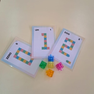 May include: A set of three ceramic mugs with a speckled, matte finish. The mugs are in shades of cream, light gray, and dark gray. Each mug has a simple, minimalist design, perfect for coffee or tea.