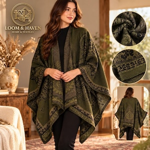 May include: An olive green open-front poncho featuring a dark black floral and paisley pattern throughout. The garment has a wide collar, draped silhouette, and a detailed border design. The Loom & Haven Home & Textiles logo is visible.