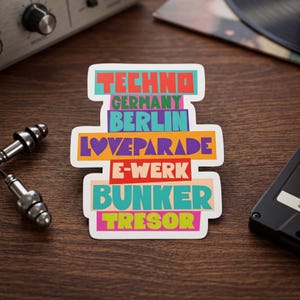 May include: A rectangular sticker featuring stacked text in vibrant colors. The words read TECHNO, GERMANY, BERLIN, LOVEPARADE, E-WERK, BUNKER, and TRESOR. Each word is set against a solid colored background block, including teal, pink, purple, orange, red, and yellow.