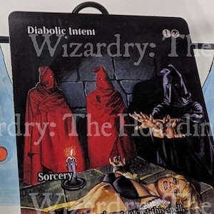 May include: A collectible card featuring the text "Diabolic Intent" and "Sorcery." The artwork depicts robed figures, a bound person, and a candle. The card has a black background with text in white and yellow.