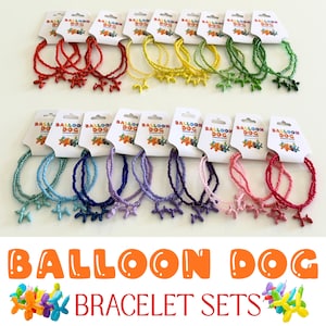 May include: A collection of beaded bracelets, each featuring a small balloon dog charm. The bracelets come in various colors including red, yellow, green, light blue, dark blue, purple, pink, and magenta, all attached to white display cards.