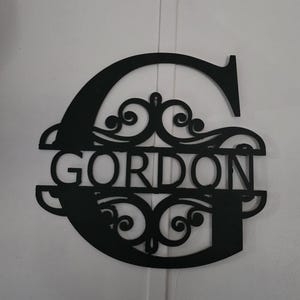 May include: A rustic wooden sign with the text "Welcome to our home" in white lettering. The sign features a distressed finish and a simple, inviting design, perfect for a front porch or entryway.