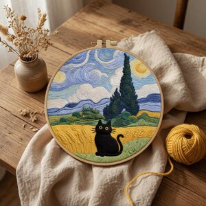 May include: A circular embroidery hoop featuring a stitched landscape inspired by a starry night sky with swirling blue clouds, a tall dark green cypress tree, and a golden wheat field. A solid black cat sits in the foreground of the scene.