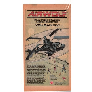May include: A vintage advertisement for an Airwolf engine-powered model helicopter. The graphic features a black helicopter in flight, the text AIRWOLF, and the slogan YOU CAN FLY. Below, small illustrations show people in a field with text.