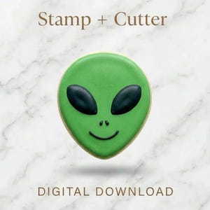 May include: A green alien-shaped biscuit with black eyes and a smile. The biscuit is on a white marble surface. Text at the top reads "Stamp + Cutter" and at the bottom "DIGITAL DOWNLOAD".