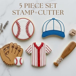 May include: A set of five baseball-themed cookie cutters and stamps. The set includes a baseball, baseball cap, baseball glove, baseball jersey, and a baseball bat. The text "5 PIECE SET STAMP+CUTTER" is at the top.
