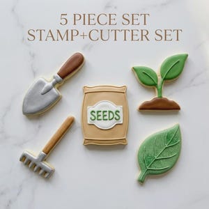 May include: A five-piece cookie cutter set with gardening-themed shapes. Includes a shovel, rake, seed bag, leaf, and a sprout. The seed bag has the word "SEEDS" on it. The set is designed to create garden-themed cookies.