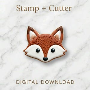 Könnte beinhalten: Ein Fuchsförmiges Ausstecher und Stempel-Set. Der Fuchs hat ein braunes und weißes Gesicht mit schwarzen Augen und einer schwarzen Nase. Der Text "Stamp + Cutter" und "DIGITALER DOWNLOAD" ist abgebildet.