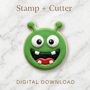May include: A green cookie shaped like a cartoon monster with two antennae, large white eyes with black pupils, a wide black mouth, and red lips. The cookie features white teeth and the text Stamp + Cutter and DIGITAL DOWNLOAD.