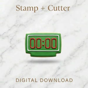 Puede incluir: Un cortador y sello de galletas verde con forma de reloj digital que muestra "00:00". Los números son rojos y el marco blanco. También se ven las palabras "Stamp + Cutter" y "Digital Download".