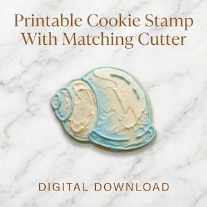 May include: A seashell-shaped biscuit with light blue and cream-coloured icing. The biscuit is outlined in light blue and sits on a marble surface. Text at the top reads "Printable Cookie Stamp With Matching Cutter" and "DIGITAL DOWNLOAD" at the bottom.