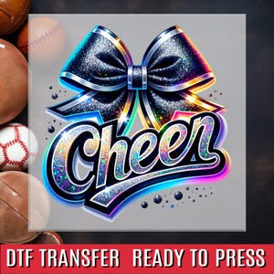 May include: A digital graphic featuring a large, glittery black bow with silver trim and the word "Cheer" in a colorful, sparkling font. The design is set against a gray background, with a red banner at the bottom.