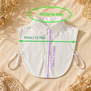 May include: A white detachable collar with a lace trim, measuring 16.54 inches across the top, 13.78 inches wide, and 11.02 inches long. The collar has a button-down front and tie closures.