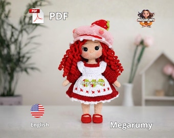 May include: A handmade crochet doll with red curly hair, wearing a white dress with red trim and a matching hat. The doll has a strawberry design on the hat and dress. The doll is wearing red shoes. The image includes the text "PDF" and "English".