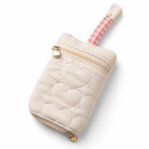 May include: Cream-colored quilted pouch with heart-shaped stitching. Features a gold zipper and heart-shaped zipper pull. The handle is a pink and white gingham pattern. The pouch is designed to hold a phone or other small items.