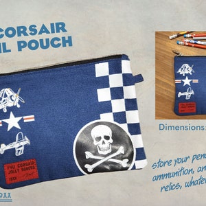 May include: A blue canvas pencil pouch with a checkered pattern, a skull and crossbones design, and a red patch that says "F4U Corsair Jolly Rogers 19XX". The pouch is 8 inches wide and 6 inches tall.