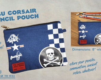 May include: A blue canvas pencil pouch with a checkered pattern, a skull and crossbones design, and a red patch that says "F4U Corsair Jolly Rogers 19XX". The pouch is 8 inches wide and 6 inches tall.