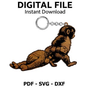 May include: A wooden keychain featuring a monkey design. The monkey is depicted in a playful pose, with brown fur and black accents. The keychain includes a metal ring and chain. The text "DIGITAL FILE Instant Download" and "PDF - SVG - DXF" are displayed.